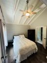 Bedroom featuring dark wood-style flooring and ceiling fan