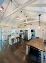 Dining room featuring dark wood-type flooring, beamed ceiling, and high vaulted ceiling