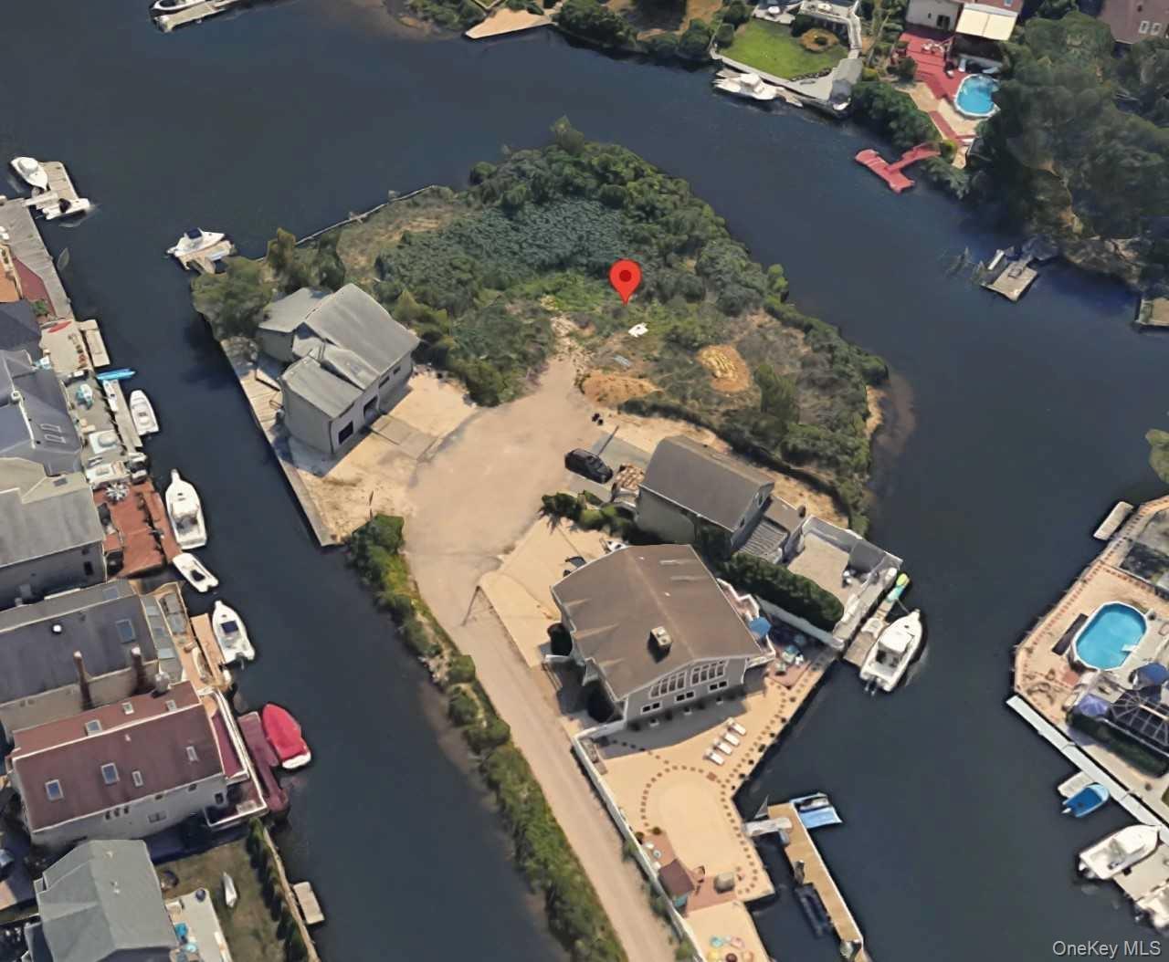 Aerial view of property's location with a large body of water