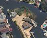 Aerial view of property's location with a large body of water