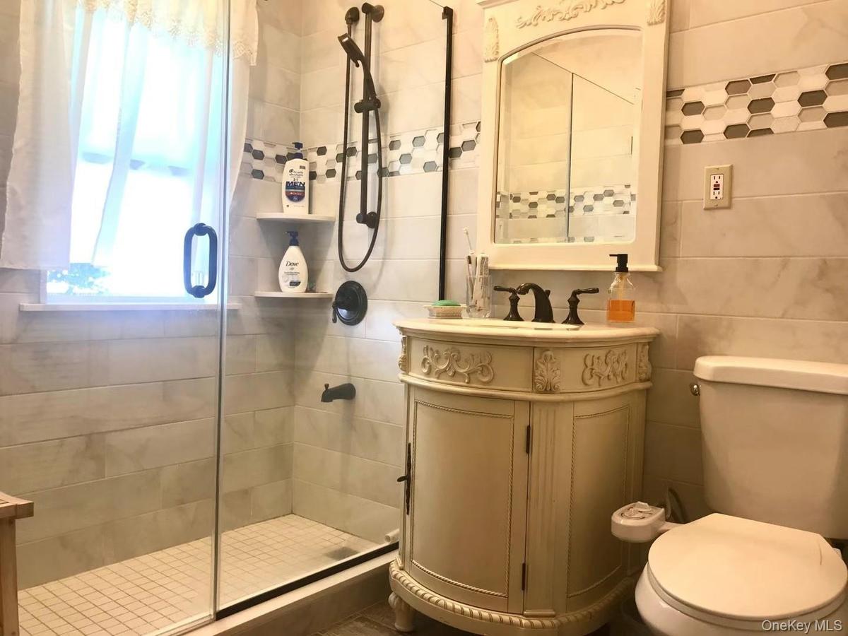 Bathroom featuring vanity and a shower stall