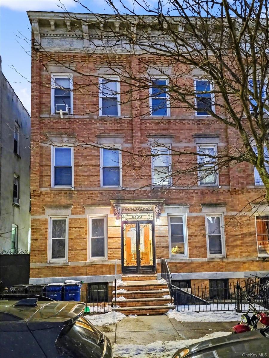 View of front facade featuring a fenced front yard and brick siding