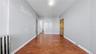 Hallway featuring radiator heating unit and dark wood finished floors