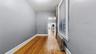 Hall with radiator and light wood-style flooring