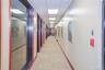 Corridor featuring baseboards and a drop ceiling
