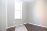 Spare room with dark wood-type flooring