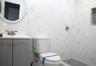 Full bath featuring vanity, tile walls, and a tile shower