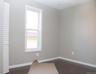 Unfurnished room with baseboards and dark wood-type flooring