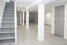 Finished basement featuring stairway, a baseboard heating unit, and recessed lighting