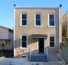 View of front facade featuring stucco siding and entry steps