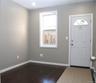 Foyer entrance featuring dark wood-style flooring, healthy amount of natural light, and baseboard heating