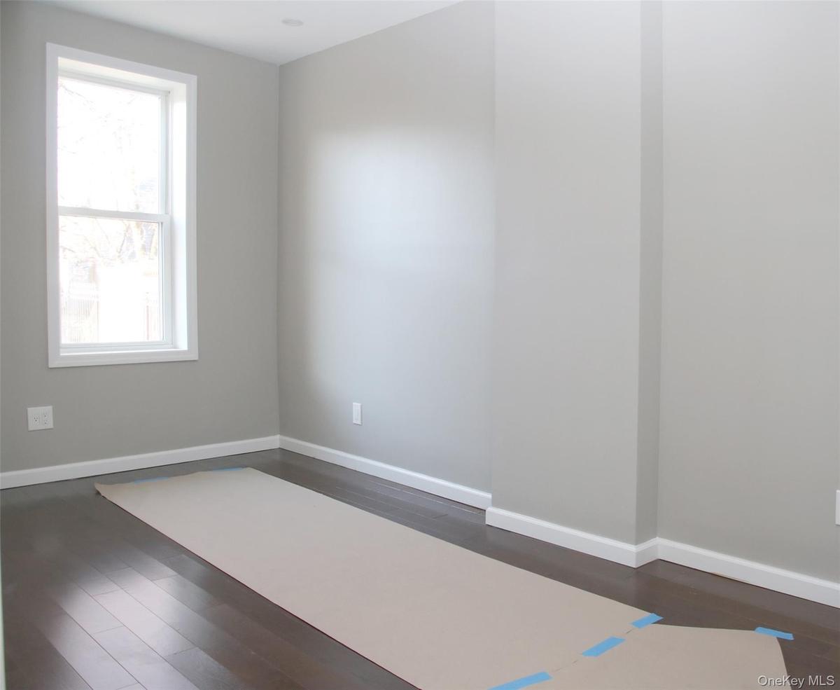 Empty room featuring dark wood-style floors