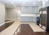 Kitchen featuring stainless steel fridge, crown molding, dark wood-style flooring, gas range oven, and tasteful backsplash