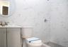 Full bathroom with tile walls, vanity, a tile shower, and marble look tile flooring