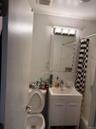 Full bathroom with vanity, shower / bathtub combination with curtain, decorative backsplash, and tile walls