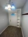 Entrance foyer featuring wood tiled floors and a chandelier
