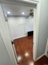 Hall featuring dark wood-type flooring, radiator, and recessed lighting