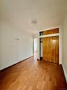 Unfurnished bedroom with wood finished floors and a closet
