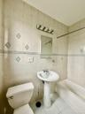 Bathroom with tile patterned floors, tub / shower combination, and tile walls