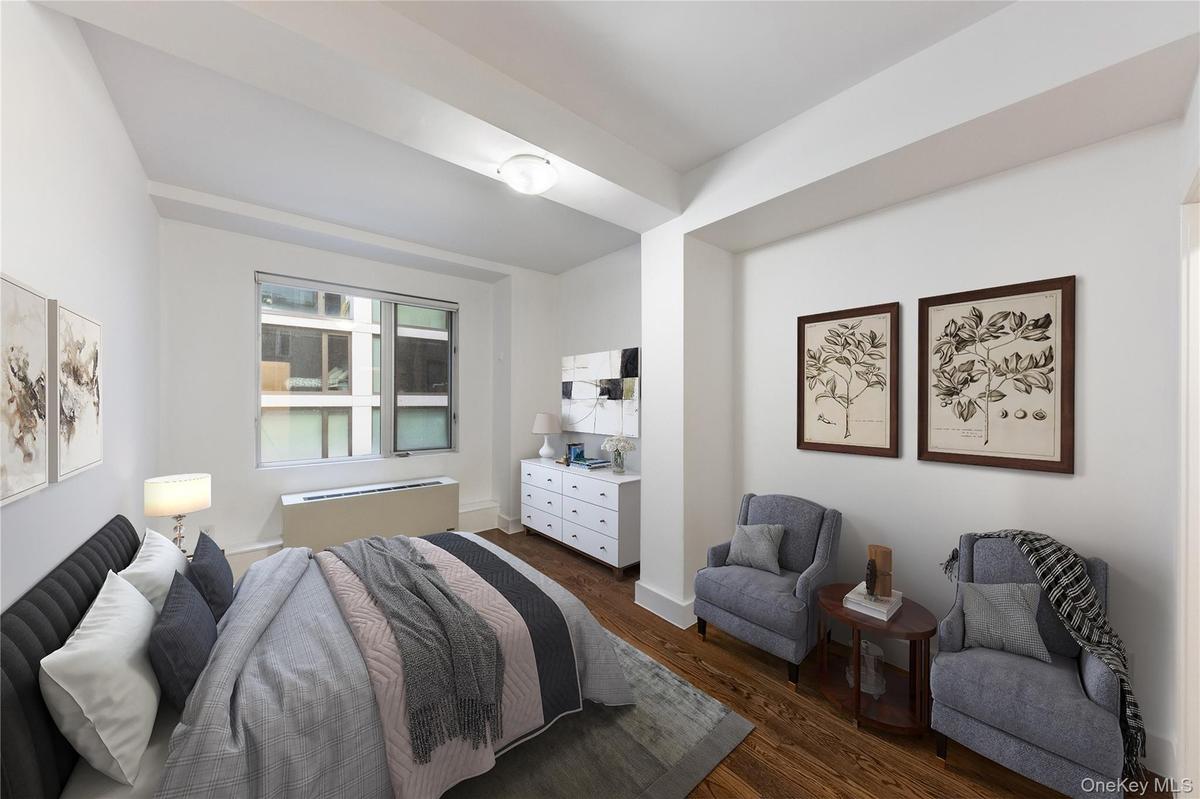 Bedroom with dark wood-style flooring and radiator
