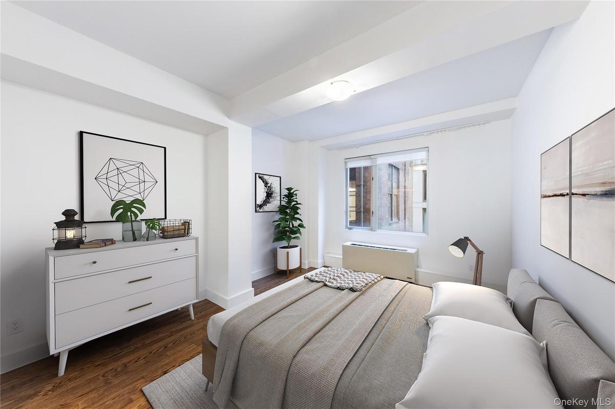 Bedroom featuring dark wood-style flooring and radiator heating unit