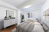 Bedroom featuring dark wood-style flooring and radiator heating unit
