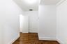 Unfurnished room with dark wood-style flooring and baseboards