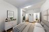 Bedroom featuring dark wood-style floors and baseboards