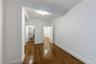Unfurnished bedroom featuring dark wood-type flooring and baseboards