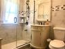 Bathroom featuring vanity and a shower stall