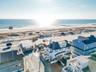 Aerial view of residential area featuring waterfront with a beach