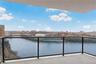 Balcony featuring a skyline view and a water view