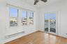 Spare room with a baseboard radiator, plenty of natural light, light wood-style flooring, and a ceiling fan