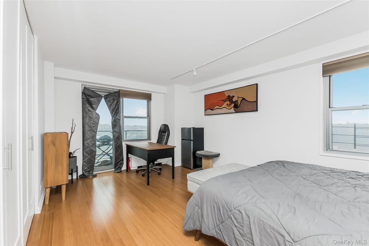 Bedroom featuring freestanding refrigerator and light wood-type flooring