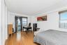 Bedroom featuring freestanding refrigerator and light wood-type flooring