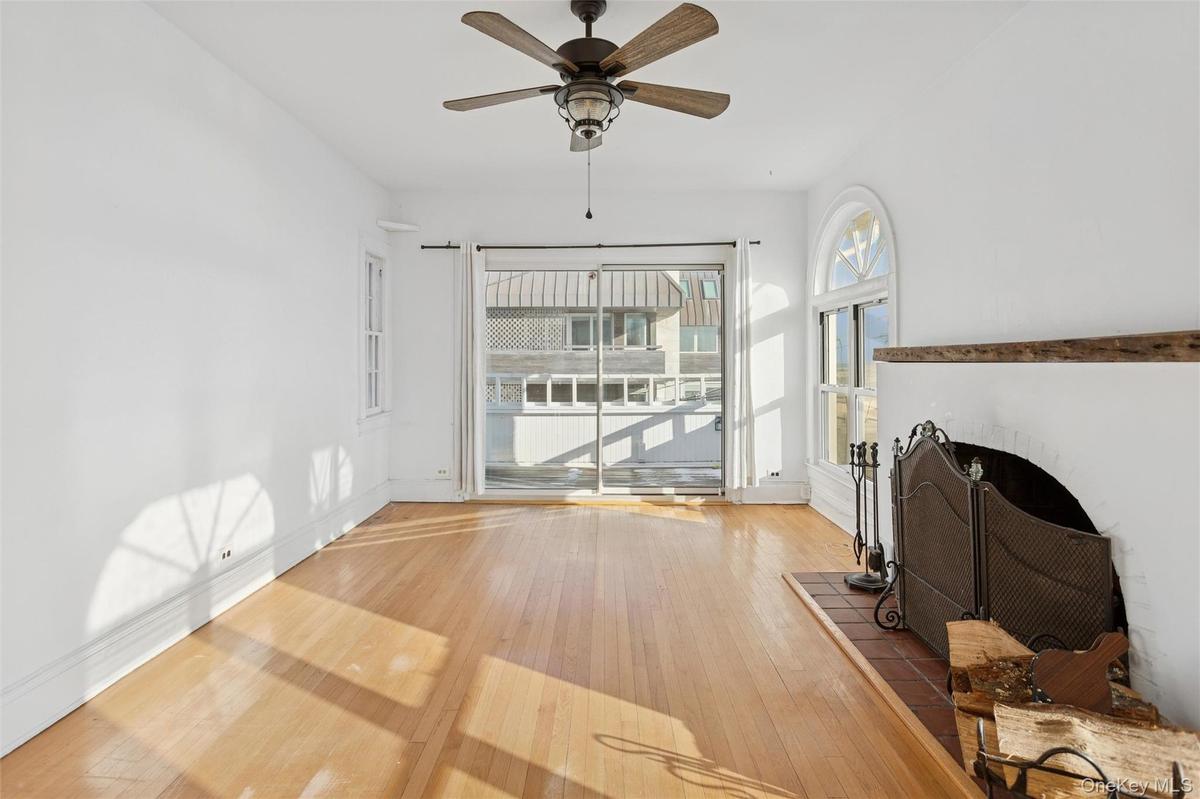 Unfurnished living room with hardwood / wood-style flooring and a ceiling fan