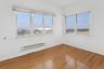 Unfurnished room with baseboard heating and hardwood / wood-style floors