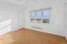 Spare room featuring baseboard heating, light wood-style floors, and a ceiling fan