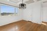 Unfurnished dining area featuring a chandelier, hardwood / wood-style flooring, coffered ceiling, and beam ceiling