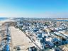 Aerial view of residential area featuring a nearby body of water