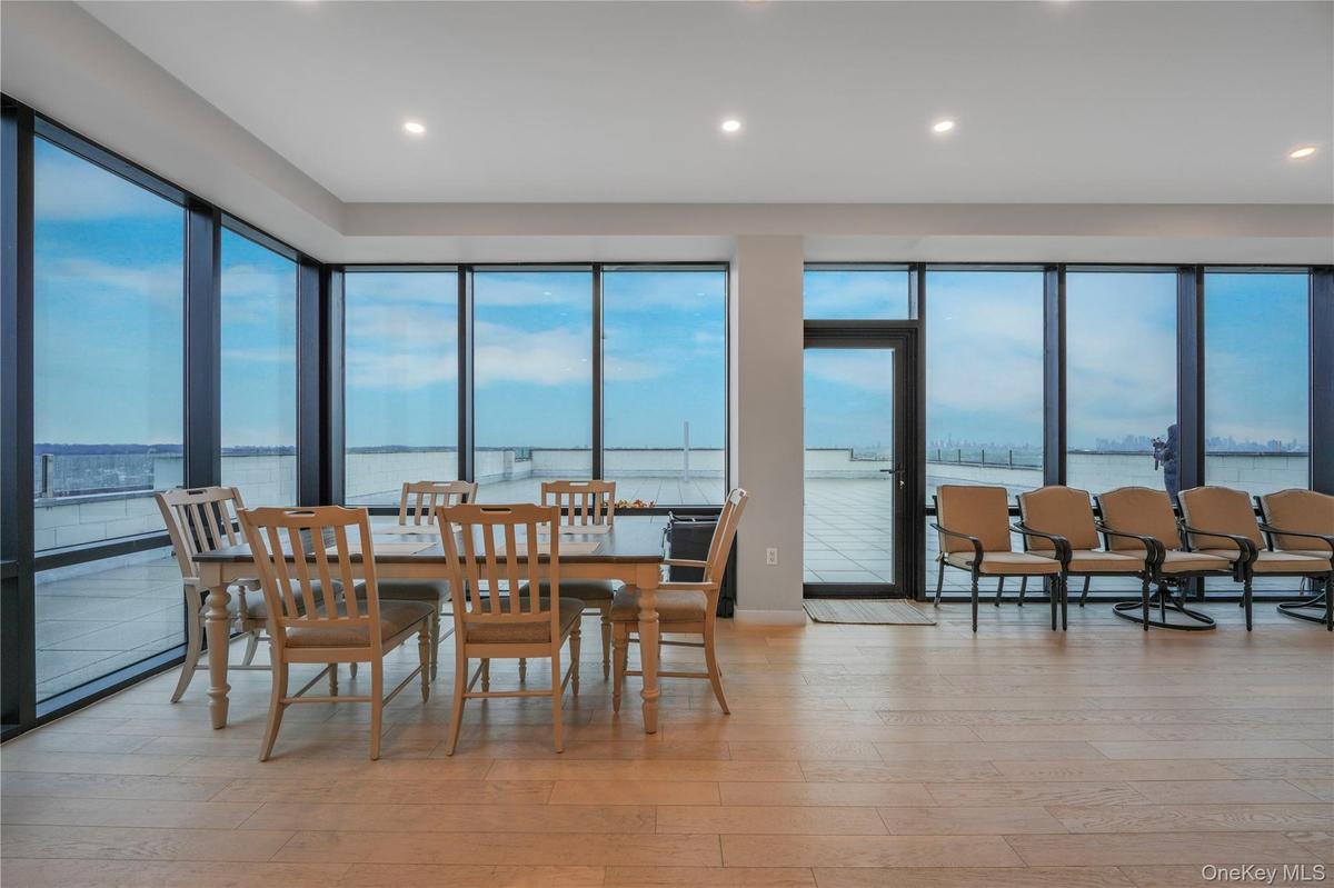 Dining space featuring a water view, light wood finished floors, healthy amount of natural light, and recessed lighting