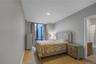 Bedroom with ensuite bath, light wood-style floors, and recessed lighting