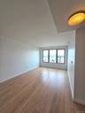 Spare room featuring baseboards and light wood-style floors