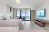 Spacious primary bedroom with ocean views