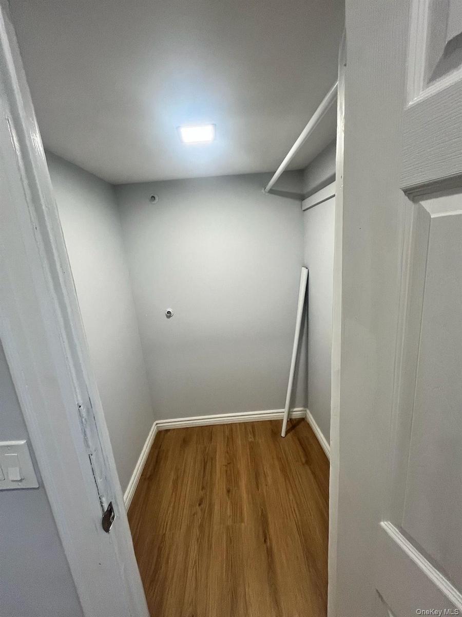 Walk in closet featuring wood finished floors