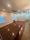 Unfurnished living room featuring dark wood finished floors, recessed lighting, a ceiling fan, and radiator heating unit
