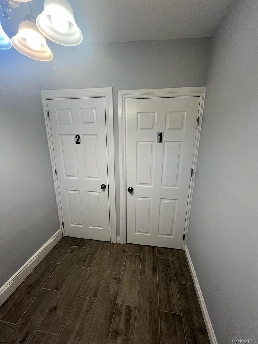 Detailed view of wood tiled floors and baseboards