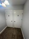 Detailed view of wood tiled floors and baseboards