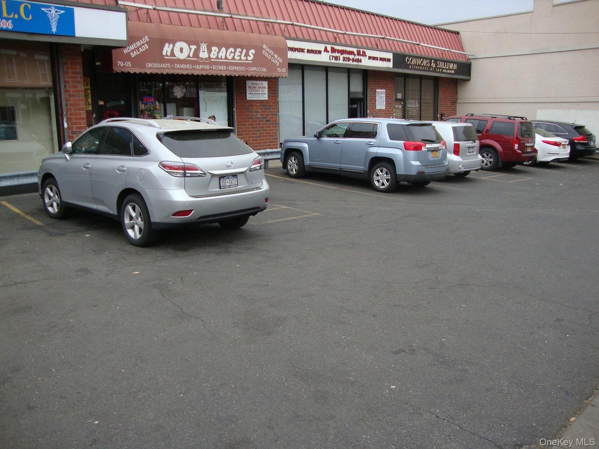 View of building exterior featuring uncovered parking