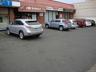 View of building exterior featuring uncovered parking